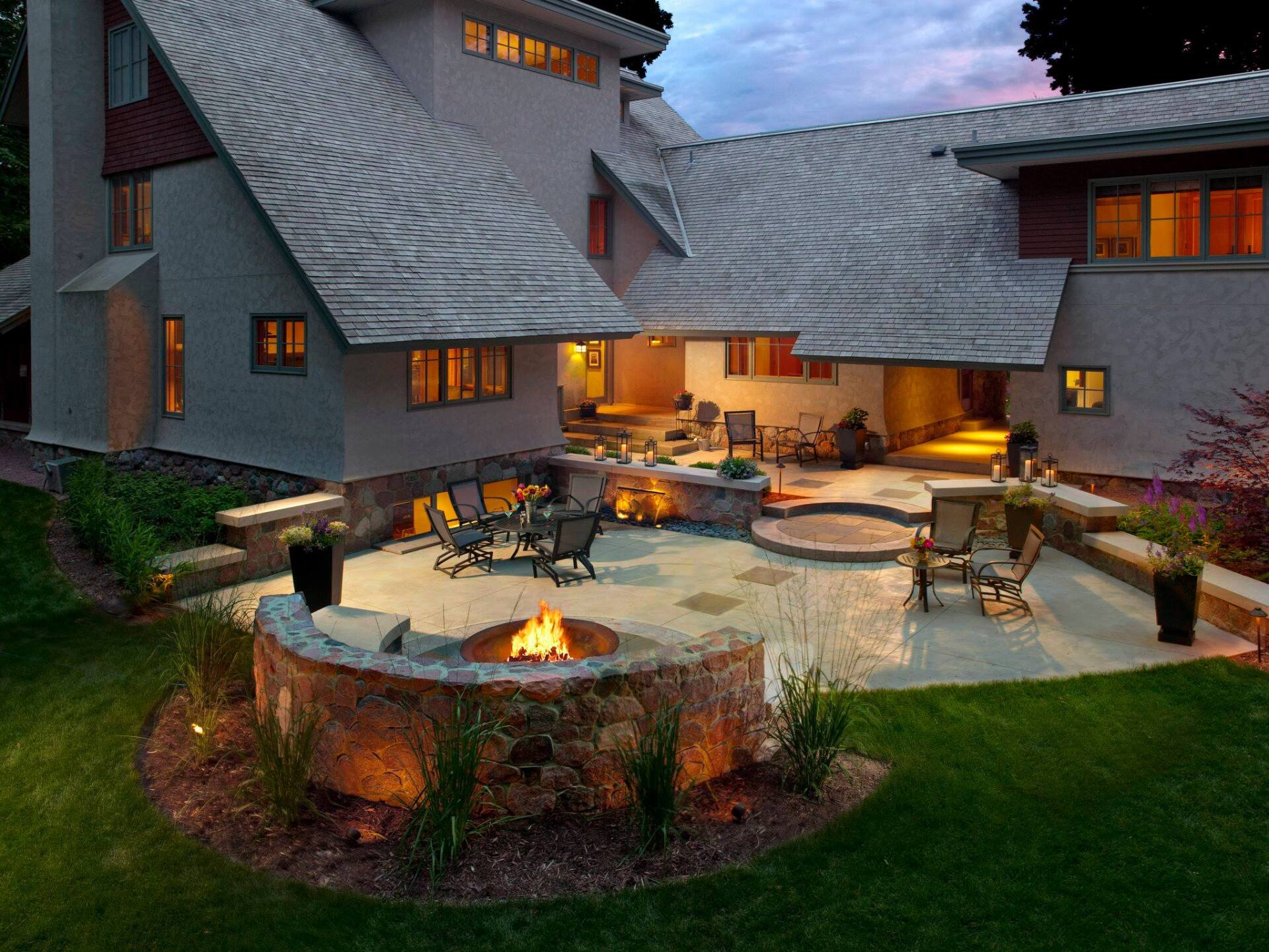 A large house with a fire pit in front of it