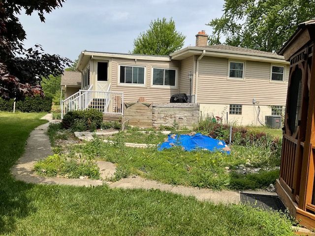 a house with a lot of grass in front of it .