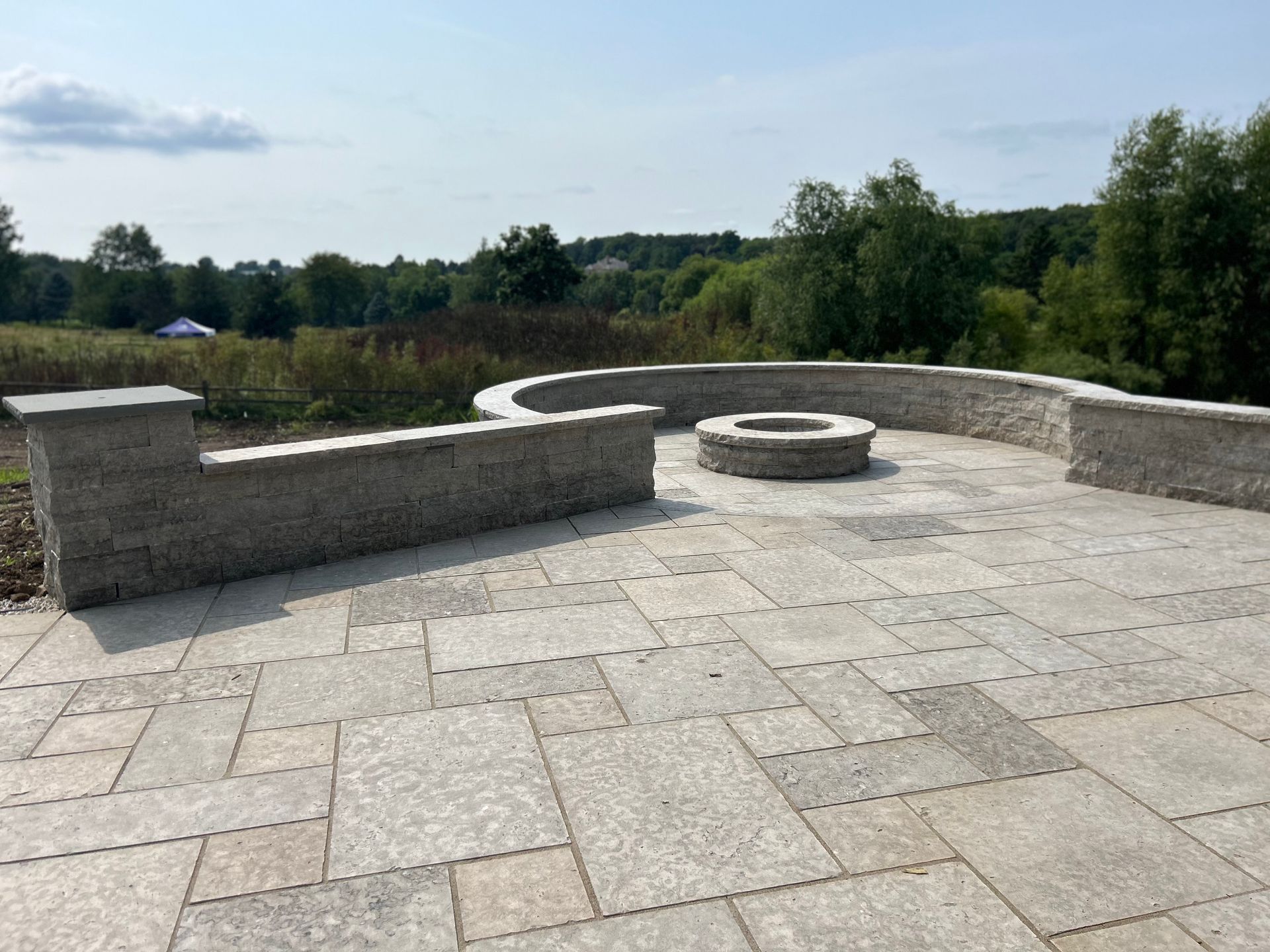 There is a fire pit in the middle of the patio.