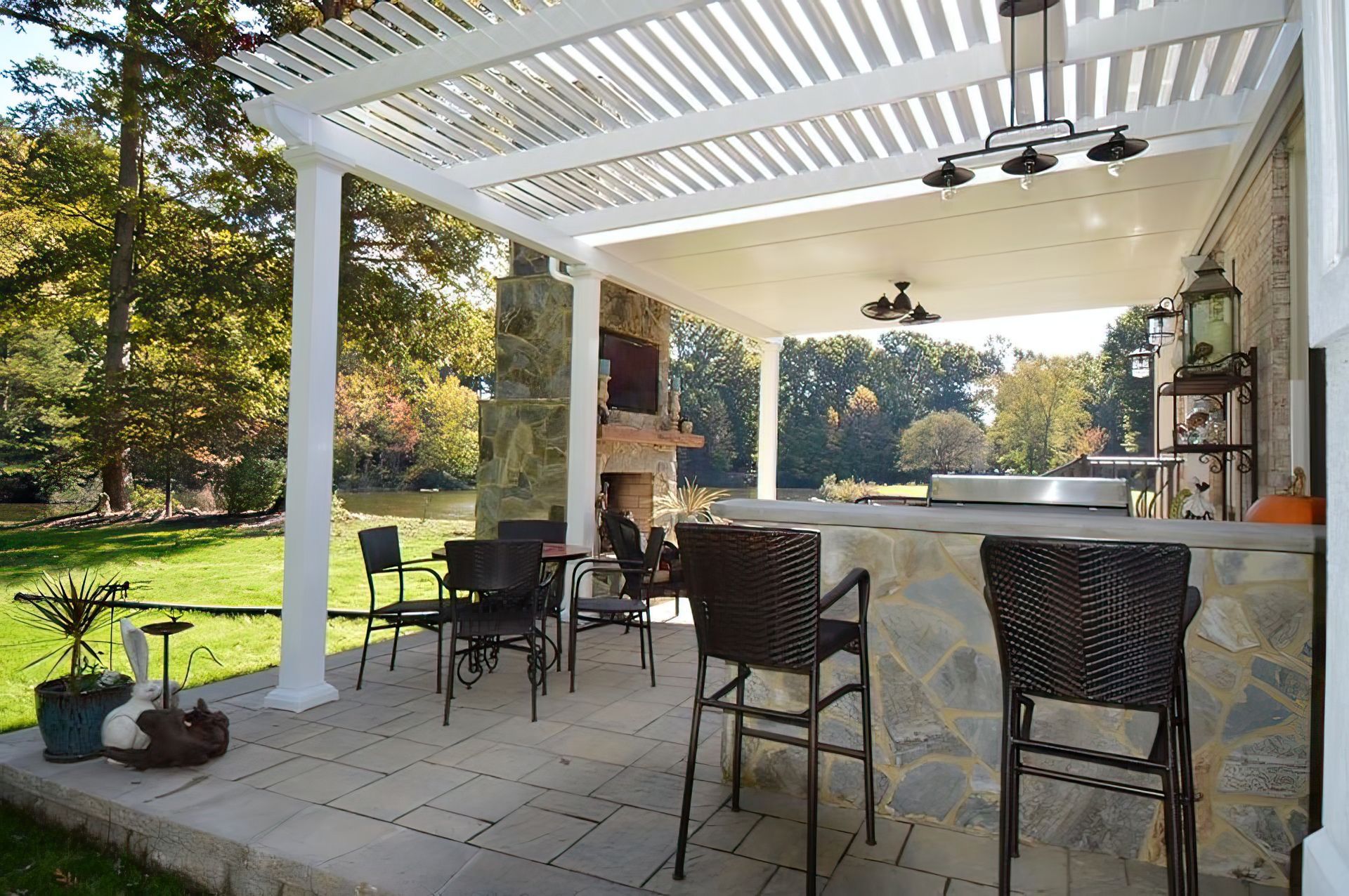 A patio with a bar and chairs under a pergola