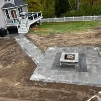 There is a fire pit in the middle of the backyard.