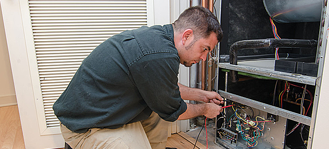 HVAC technician working on a residential heat pump