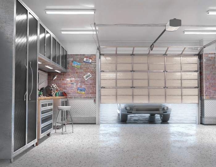 Garage interior with open door, car inside. Metallic cabinets, workbench, exposed brick wall.