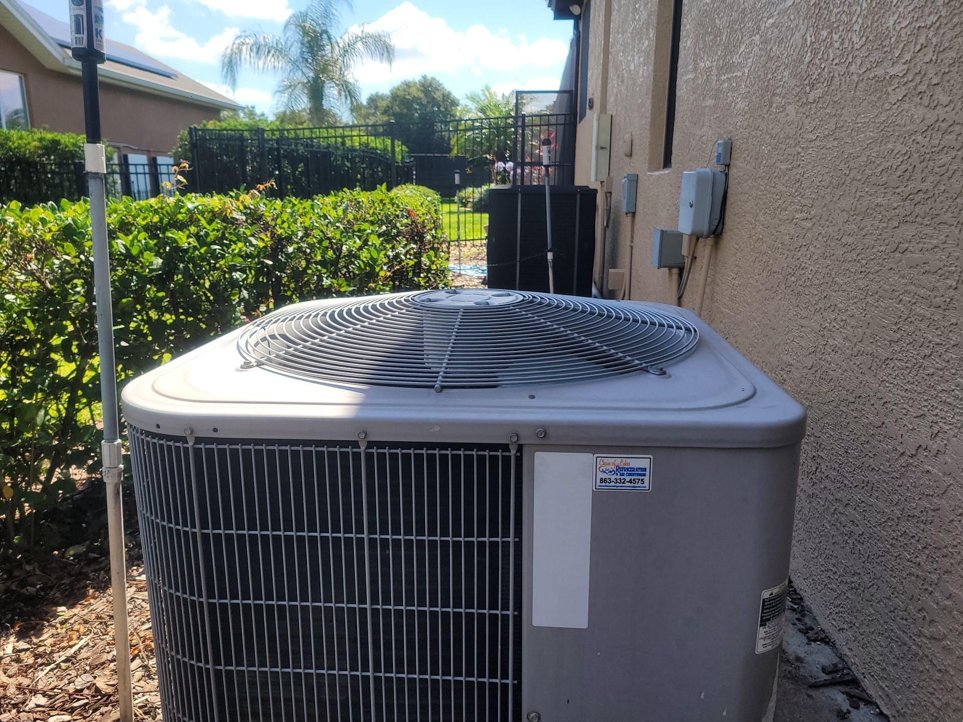 A large air conditioner is sitting on the side of a building.