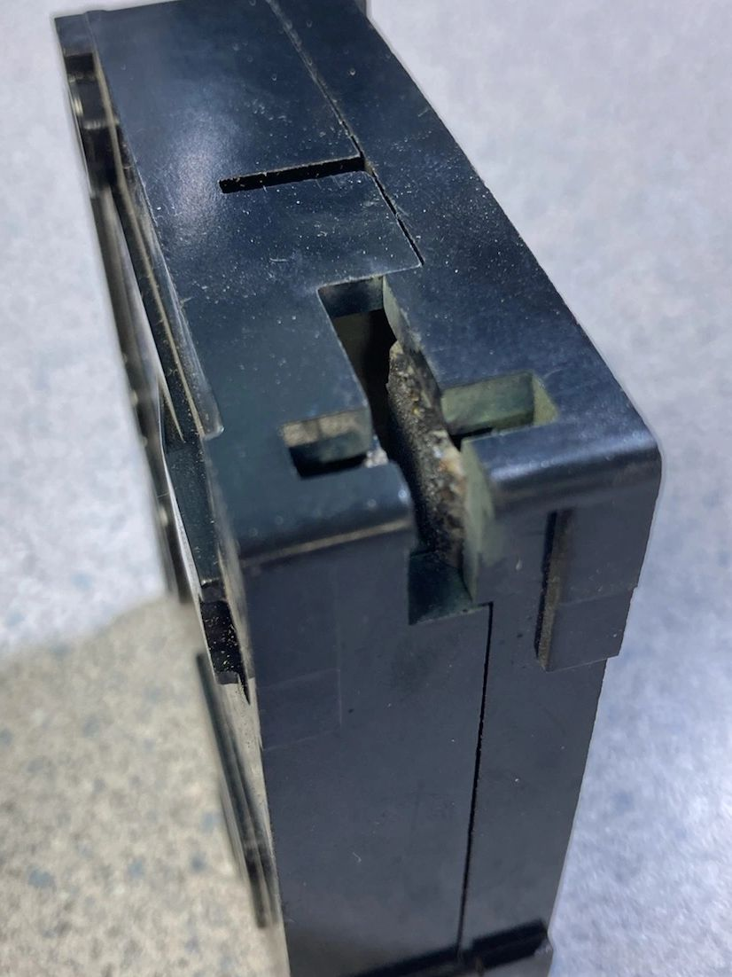 A black box with a hole in it is sitting on a table.