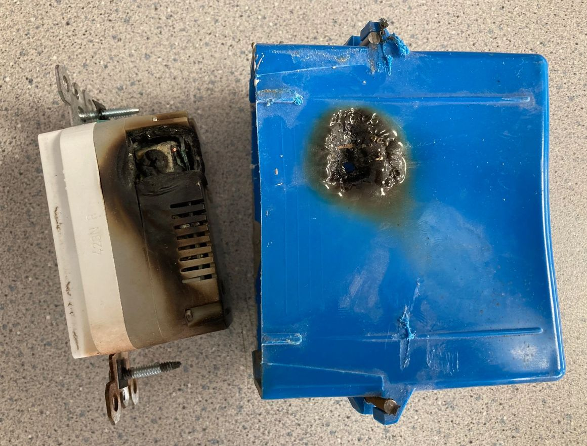 A blue box is sitting next to a white box on a table.