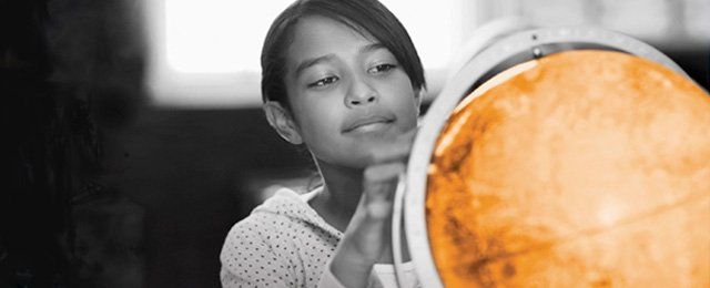 Girl looking at a globe