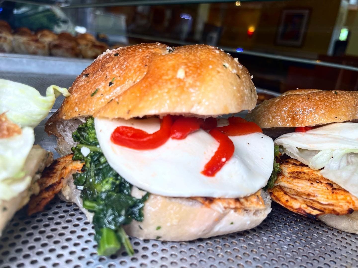 A close up of a sandwich with spinach and cheese