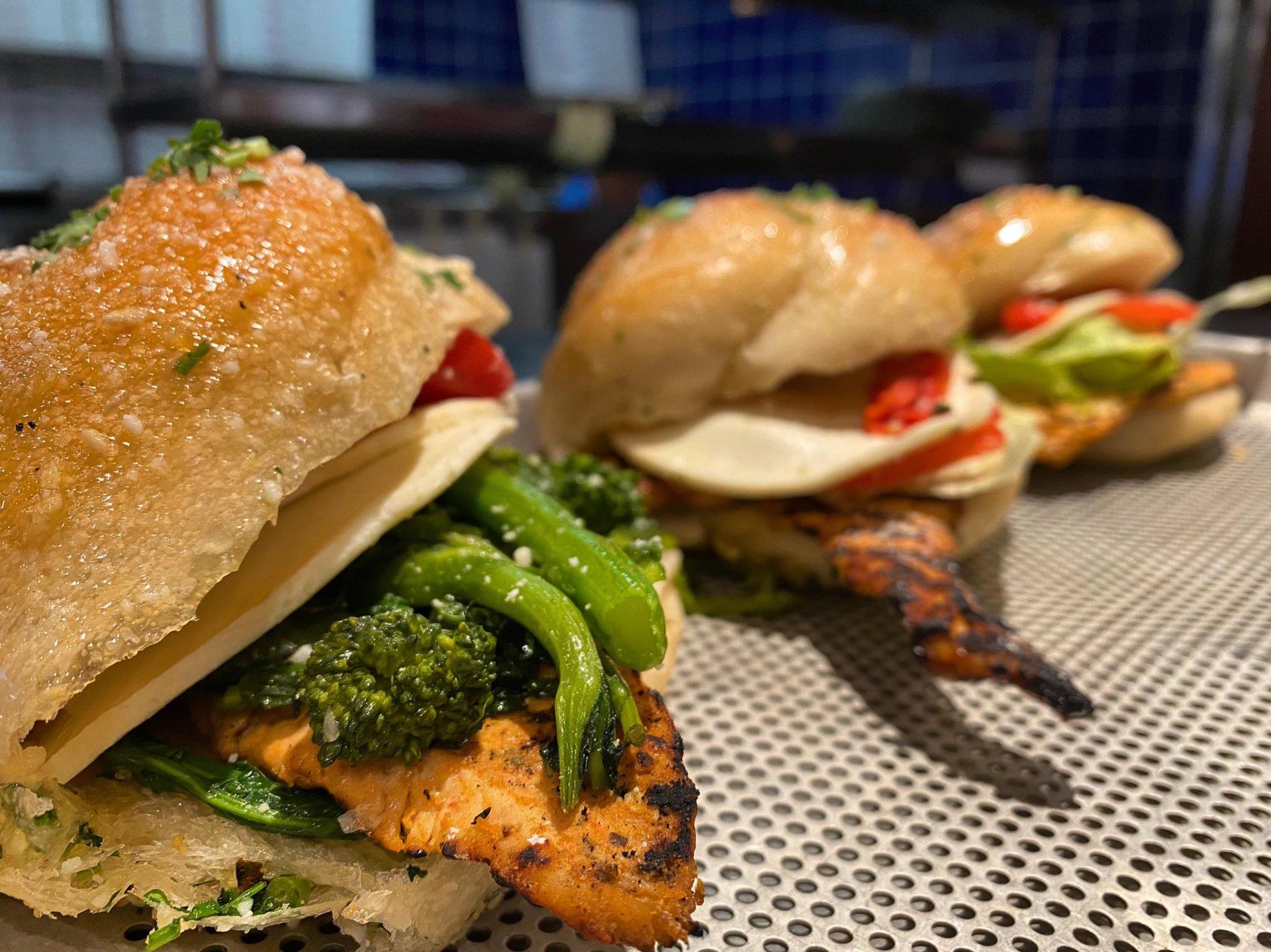 A bunch of sandwiches are sitting on a table.