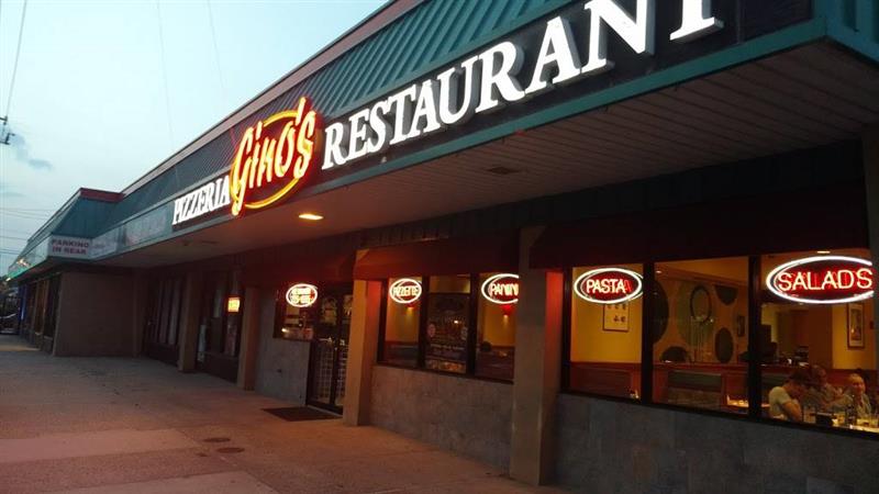A restaurant with a sign that says ' gino 's restaurant ' on it