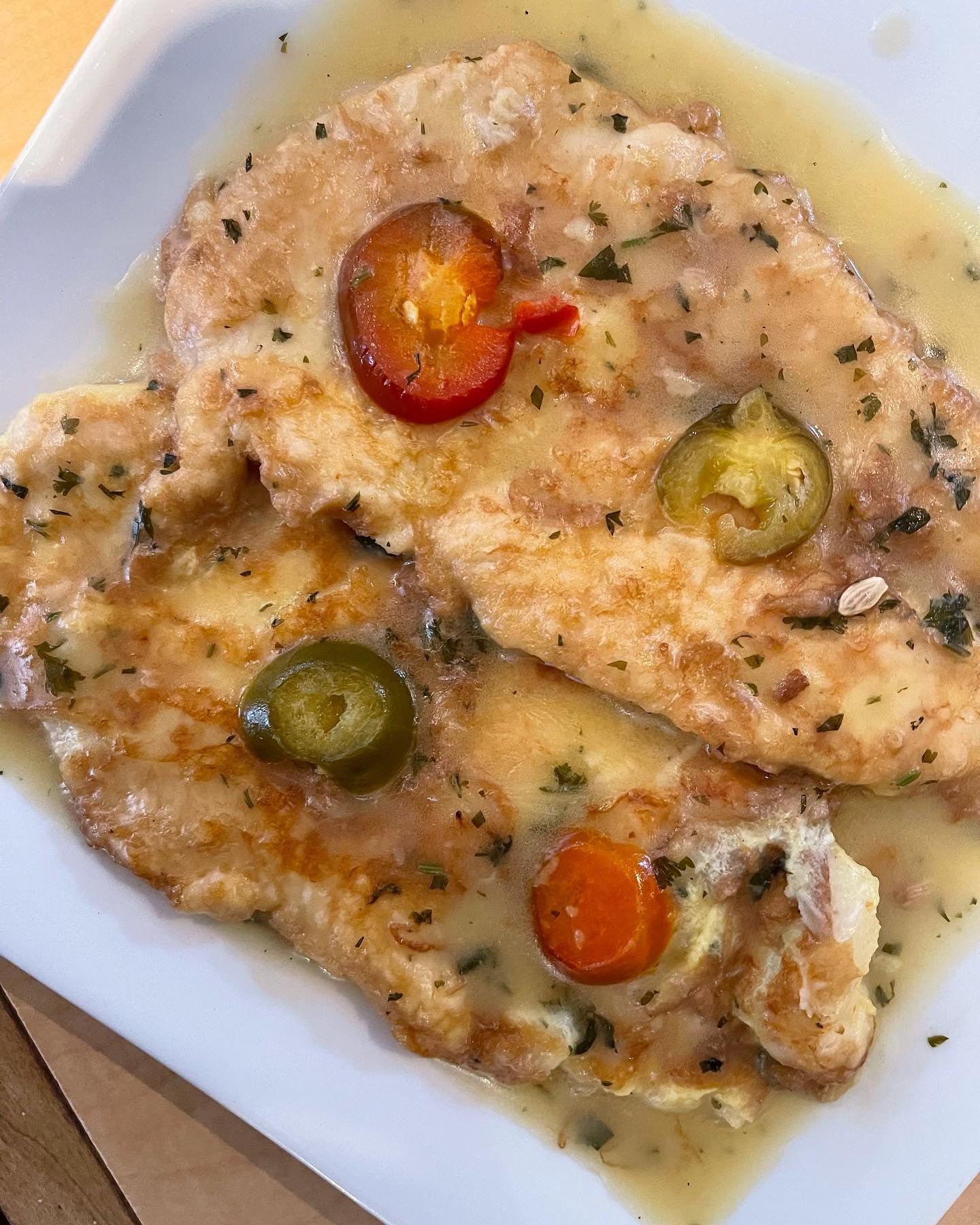 A close up of a plate of food with sauce and vegetables