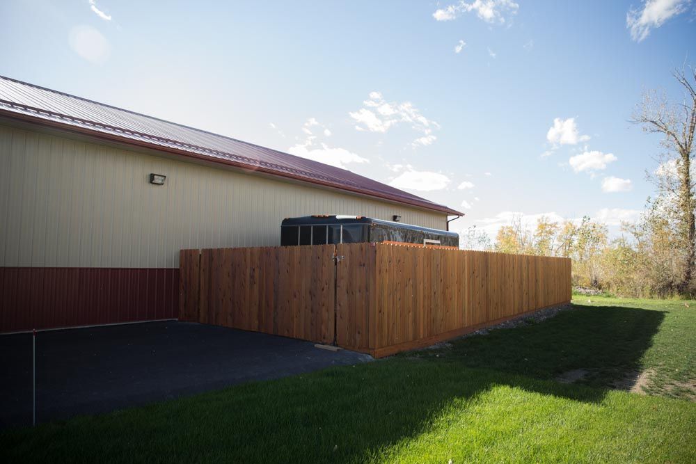A large building with a wooden fence in front of it.