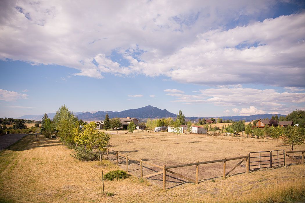 There is a wooden fence in the middle of a field.