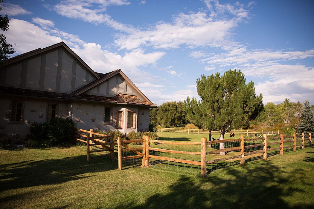 A house with a wooden fence in front of it.