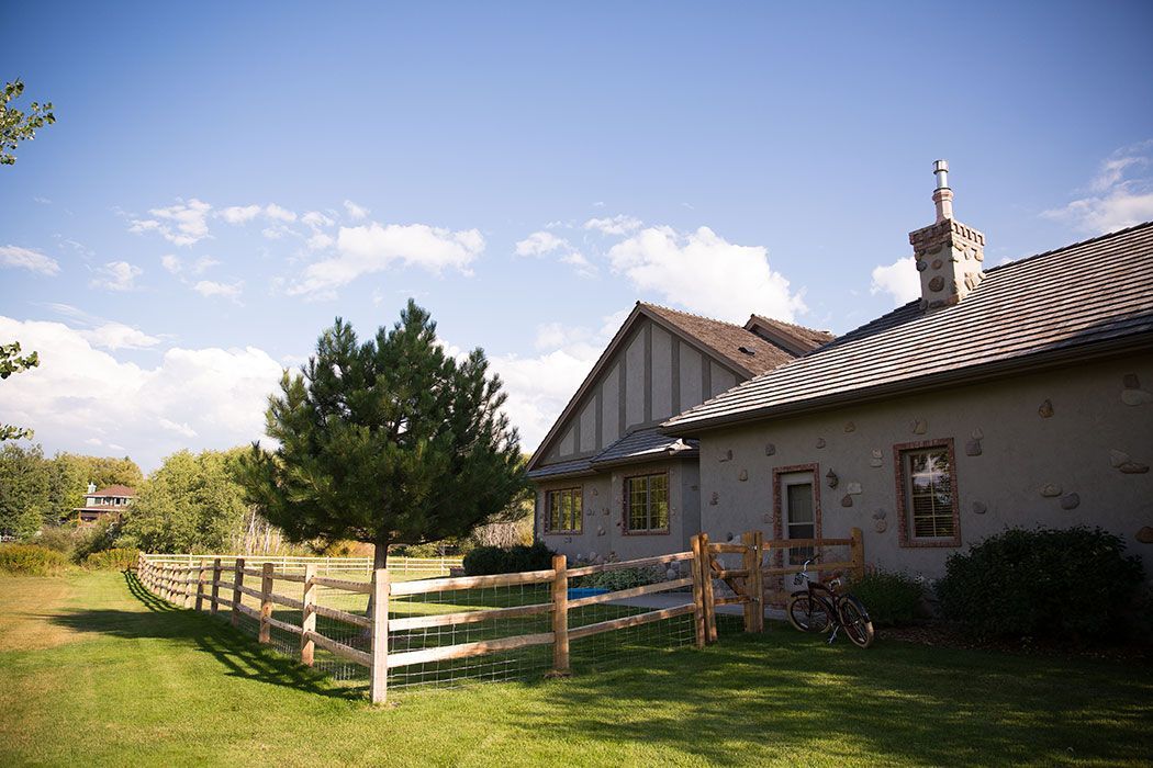 A house with a wooden fence in front of it.