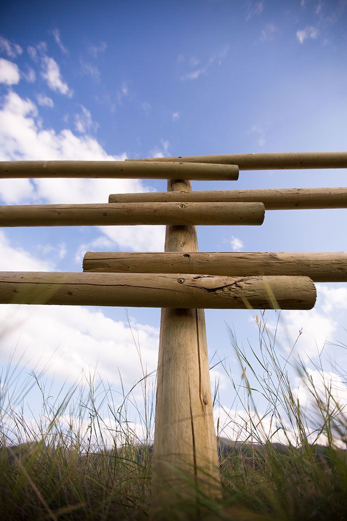 A wooden fence with a blue sky in the background.