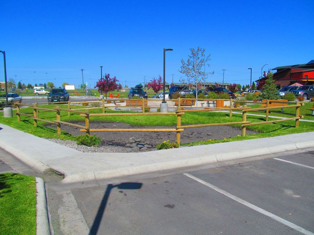 A parking lot with a wooden fence around it.