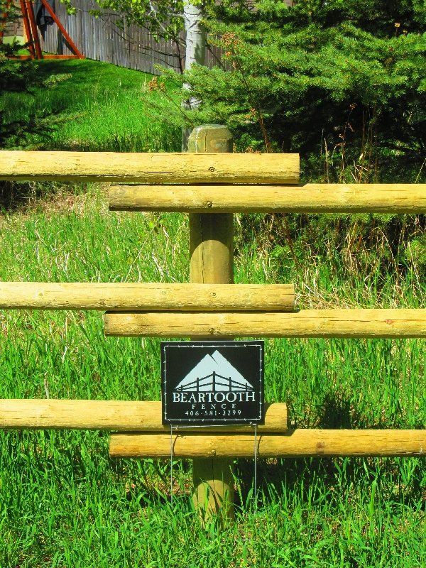 A wooden fence with a sign that says beartooth on it.