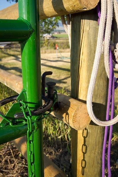 A green fence with a purple rope attached to it.