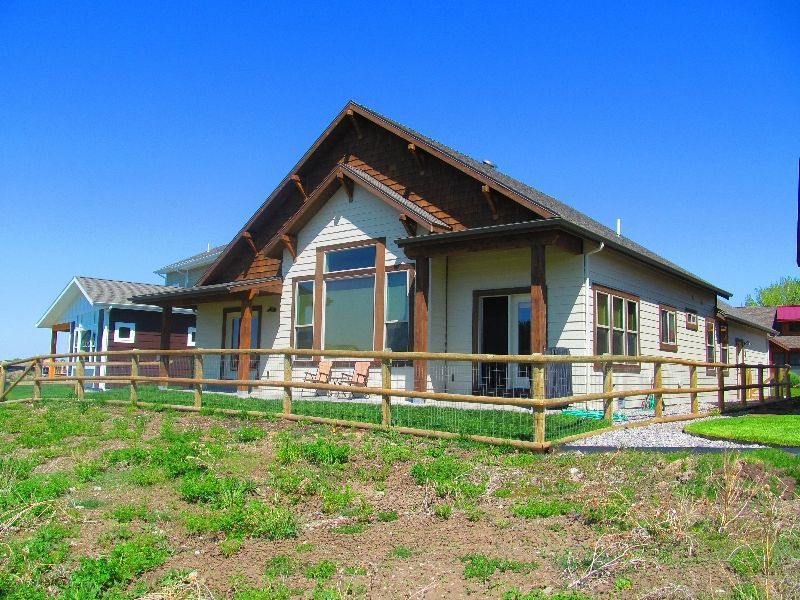 A house with a wooden fence in front of it.