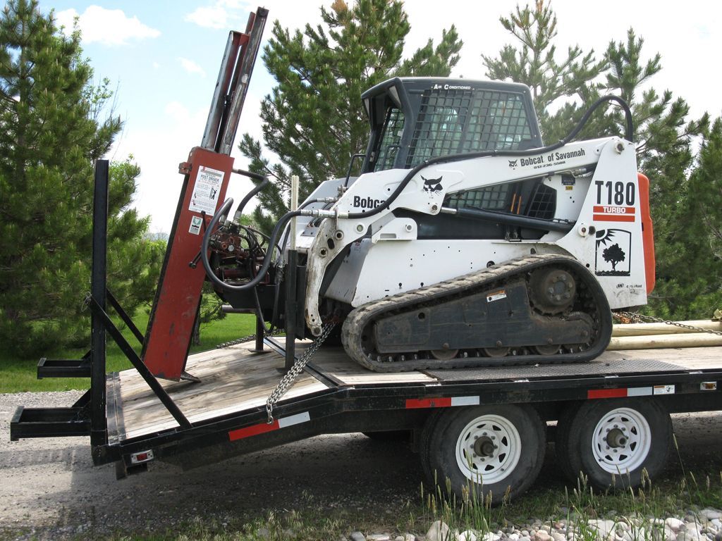 A bobcat t180 is sitting on top of a trailer.
