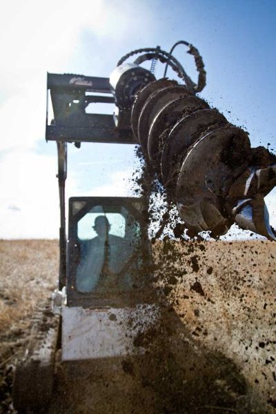 A bulldozer is digging a hole in the dirt.
