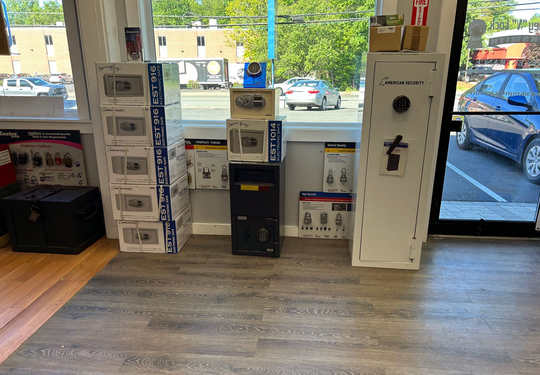 Storefront interior with display boxes and a white cabinet near the windowed entrance
