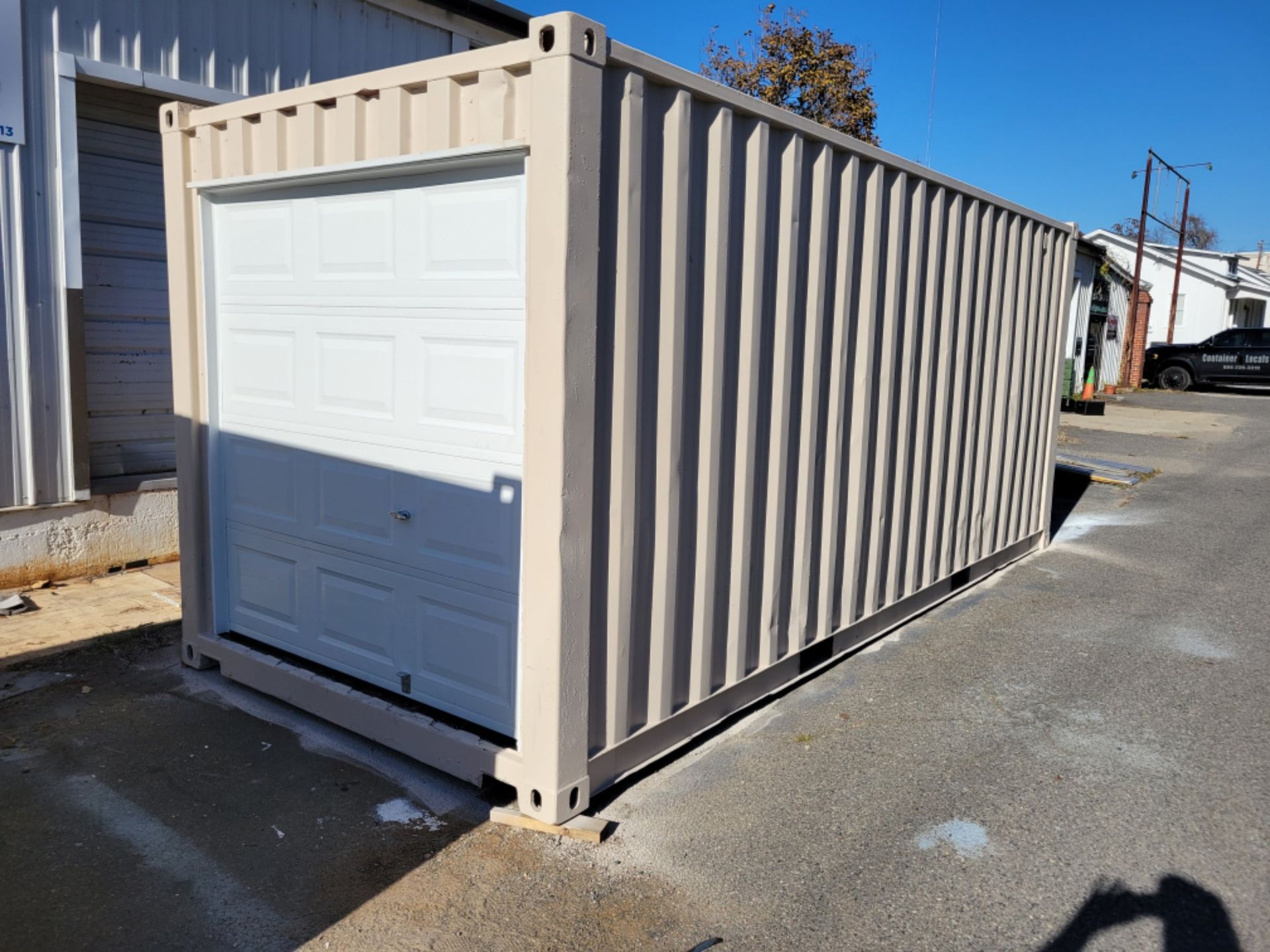A shipping container with a garage door attached to it.
