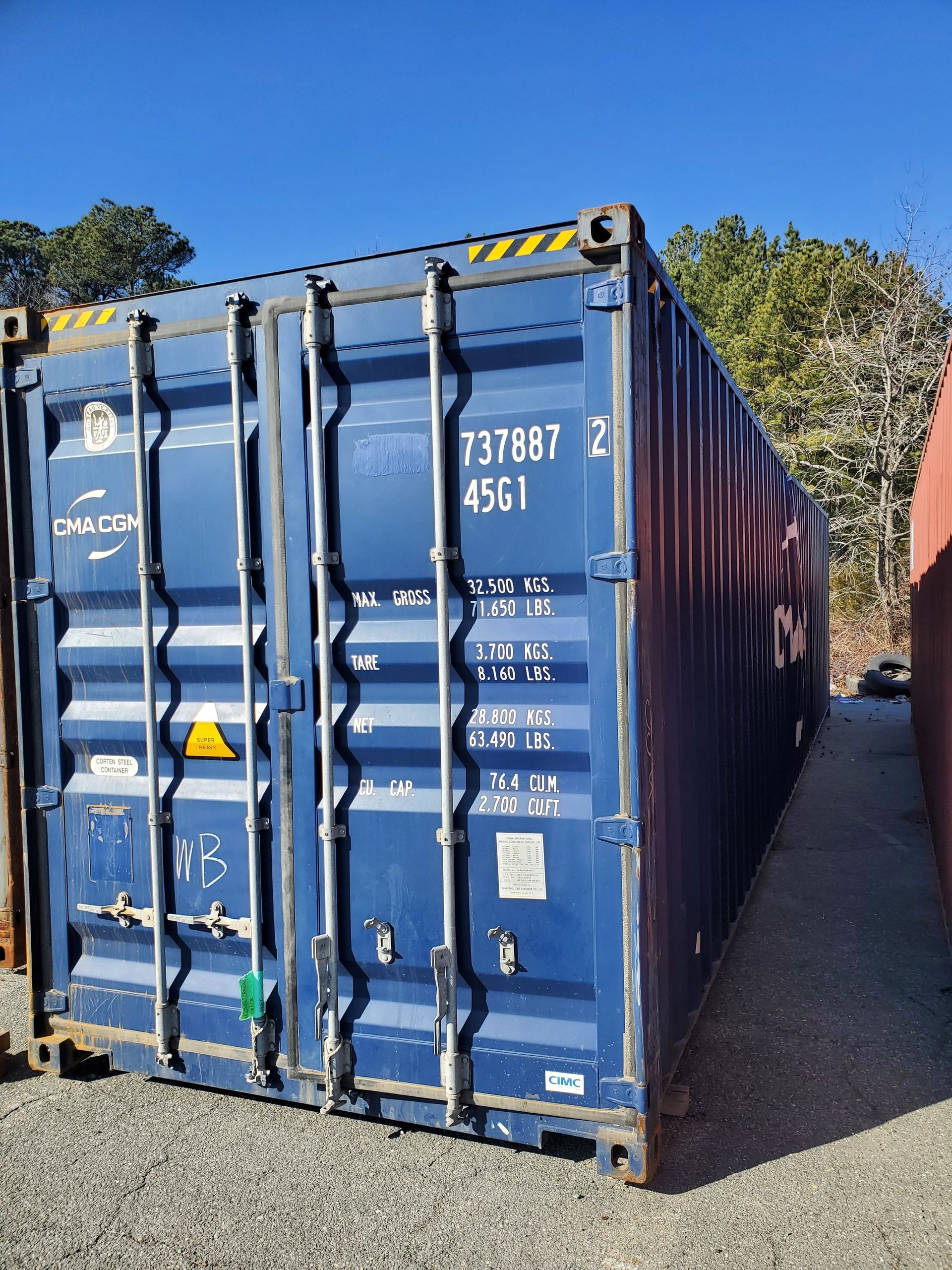 A blue shipping container with the number 737087 written on it