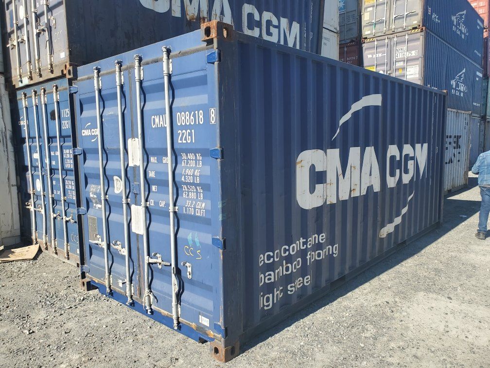 A blue shipping container with the word cgm on it