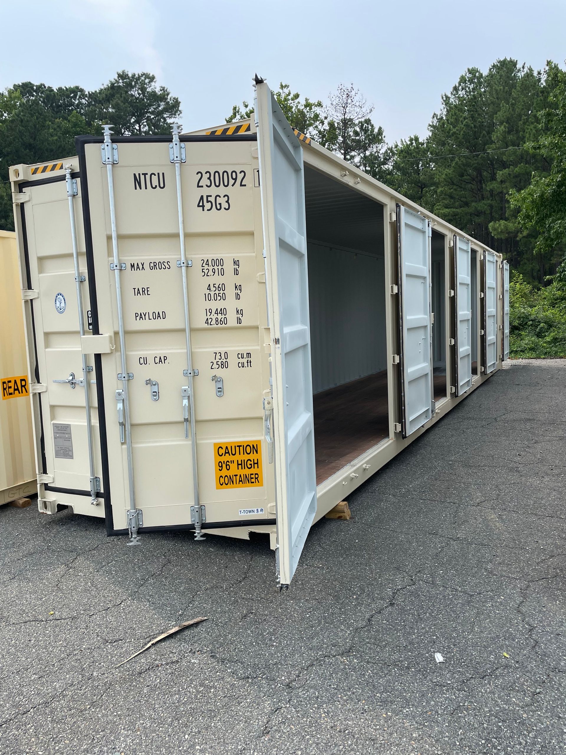 A row of shipping containers with their doors open.