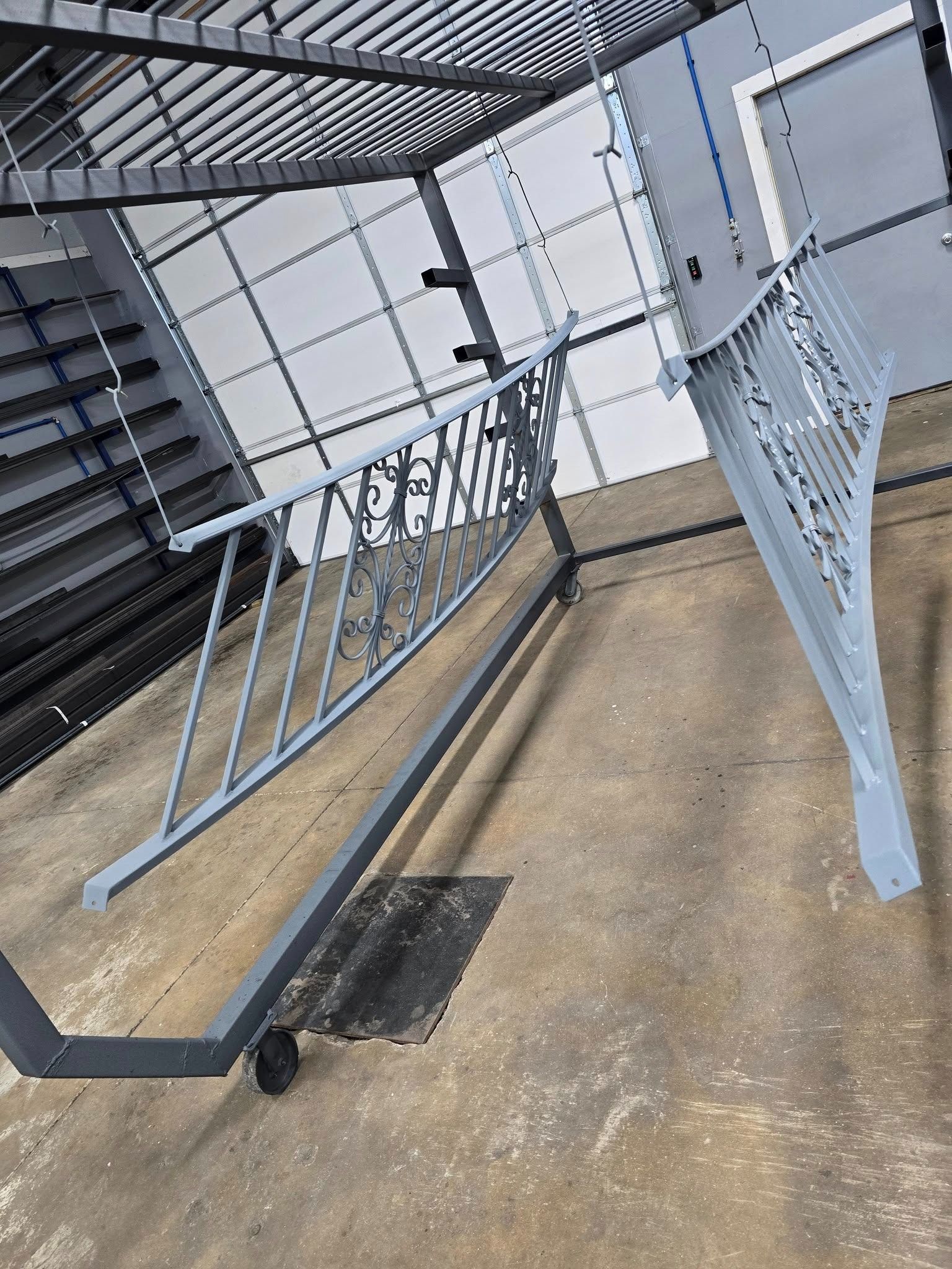 Damaged bike rack with bent metal bars under a covered outdoor staircase