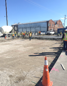 A group of construction workers are working on a road.
