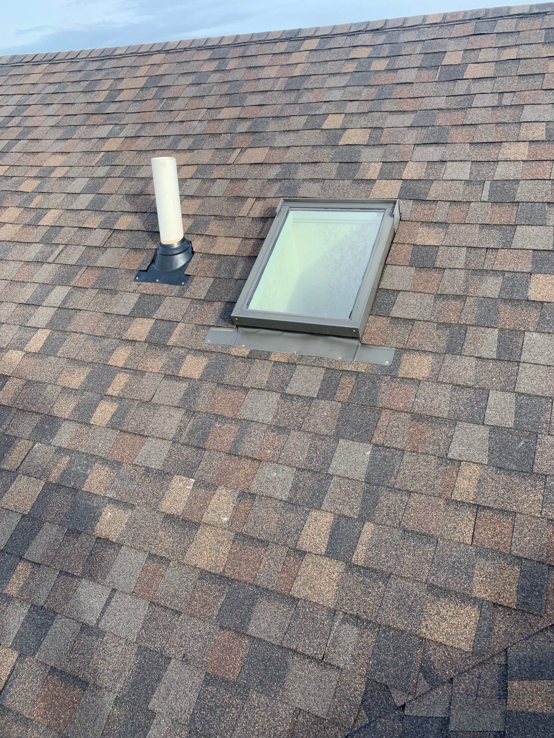 There is a skylight on the roof of a house.