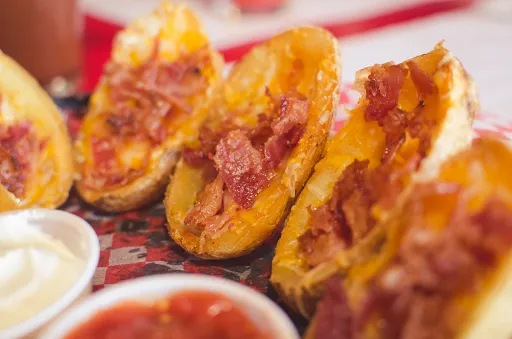 Potato skins with cheese and bacon, served with sour cream and salsa.