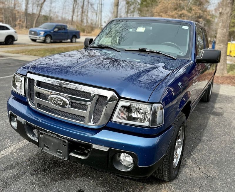 Blue Ford Ranger pickup truck parked outdoors.