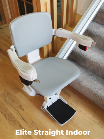 Indoor stair lift chair with gray seat and footrest on a carpeted staircase