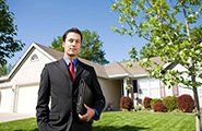Real Estate Agent In Front Of House