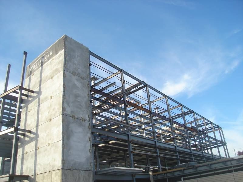 A building under construction with a blue sky in the background