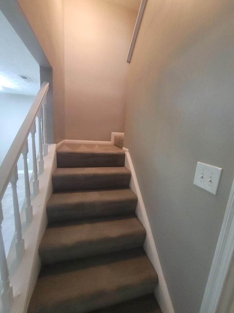 A set of stairs leading up to the second floor of a house.