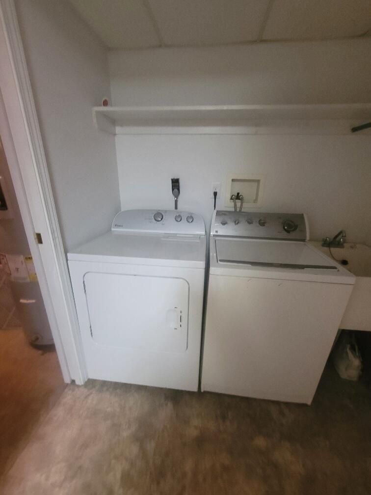 A laundry room with a washer and dryer in it.