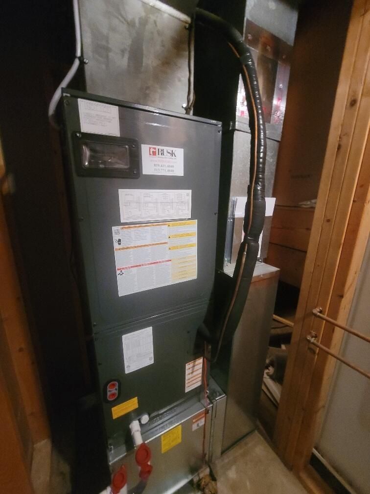 An air conditioner is sitting in a corner of a room.