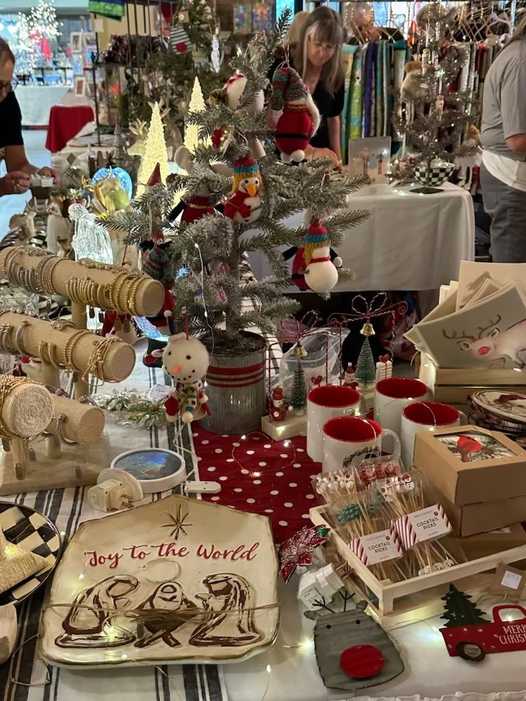 A table filled with lots of christmas decorations and a christmas tree.