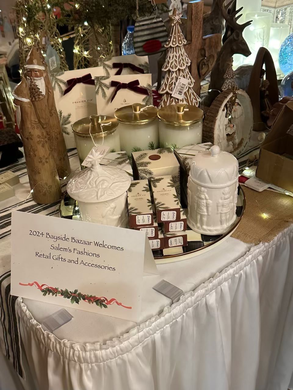 A table with candles and christmas decorations on it.