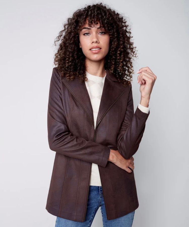 Woman with curly hair wearing a brown leather jacket