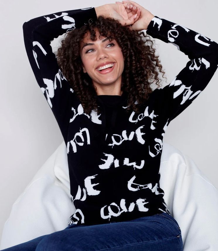 Woman sitting in a chair with her hands behind her head