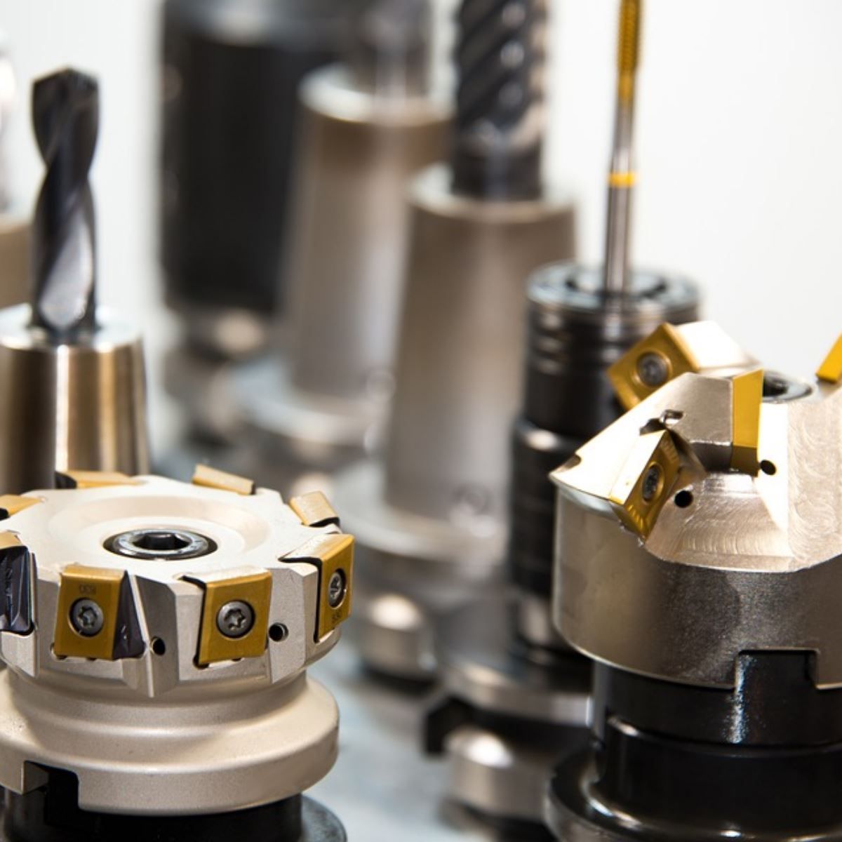 Close-up of metal milling tool holders and cutting bits in a workshop