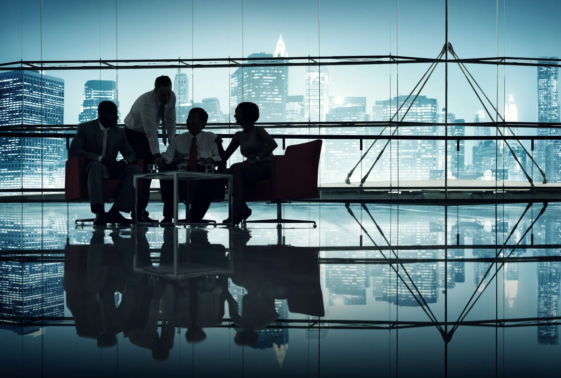 Business team in silhouette, meeting in a modern office with city skyline view.
