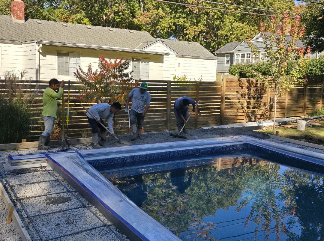 A group of men are working on a swimming pool.