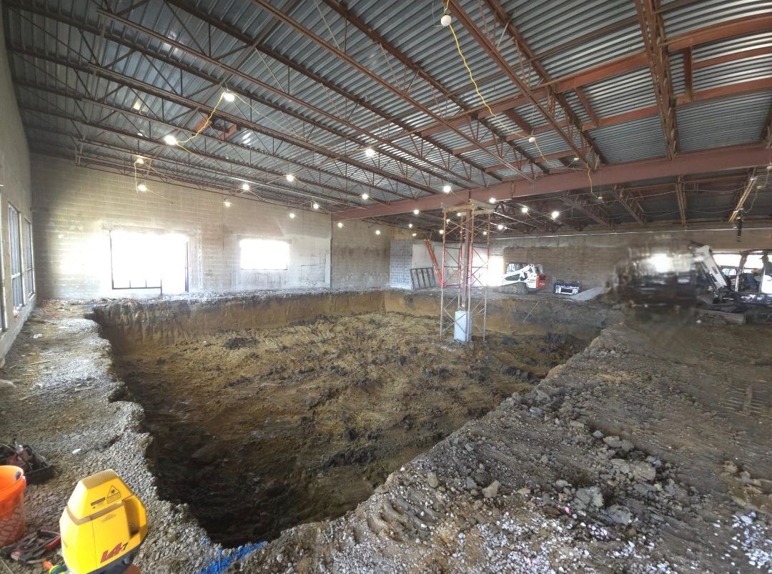 A large building under construction with a large hole in the floor.